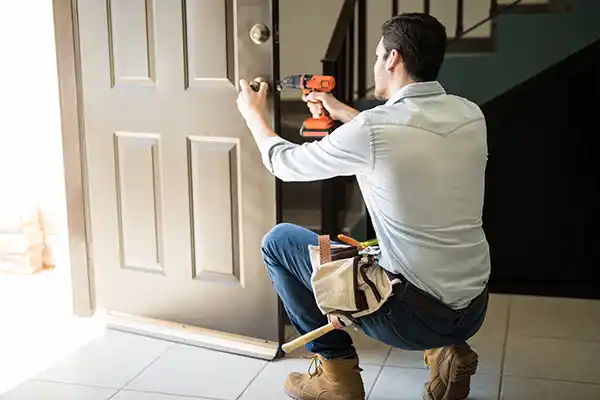 Handyman repairing a doorknob